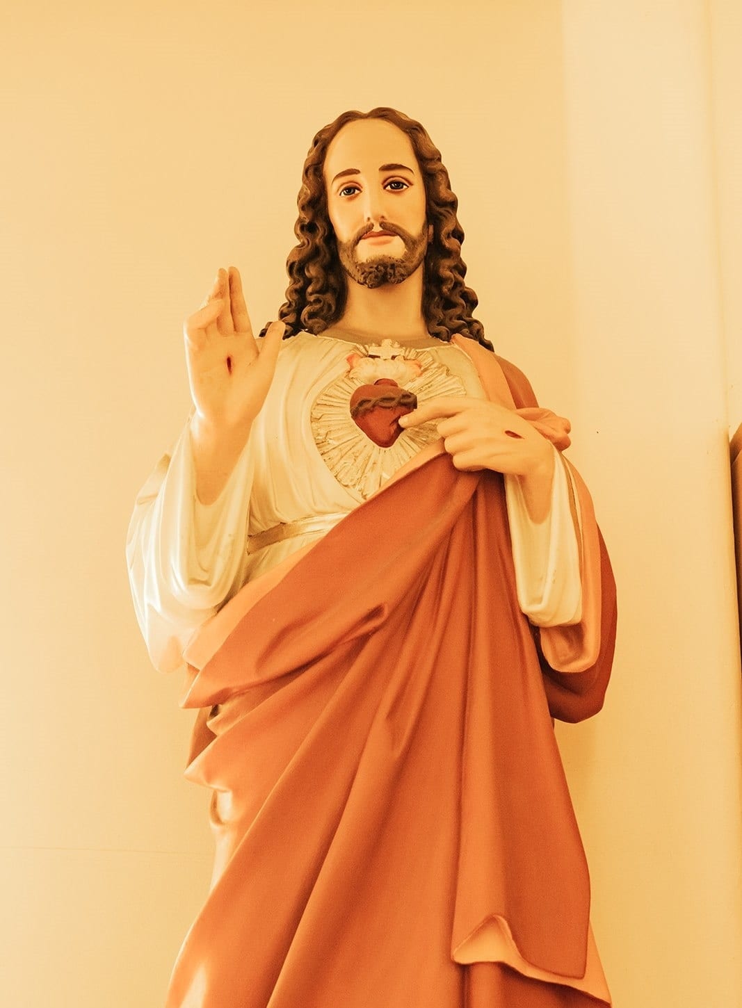 A statue of the Sacred Heart in red and white robes