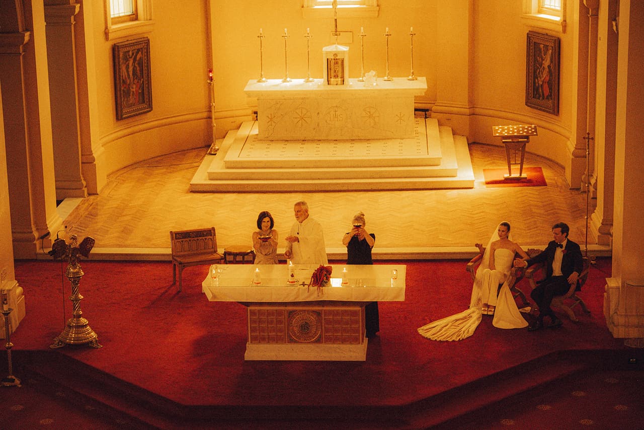 The marble altar and the old high altar behind it during a reading, Kira and Nick seated to one side