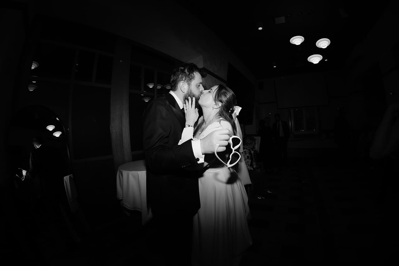 Black and white photo of Bianca and Aidan's first dance in a spotlight