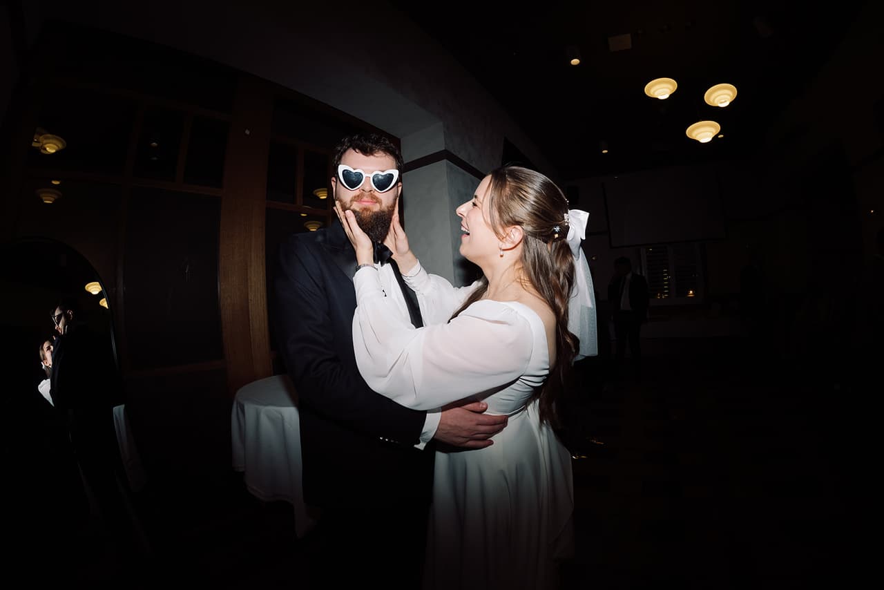 Aidan wearing the heart-shaped sunglasses as Bianca holds his face on the dance floor