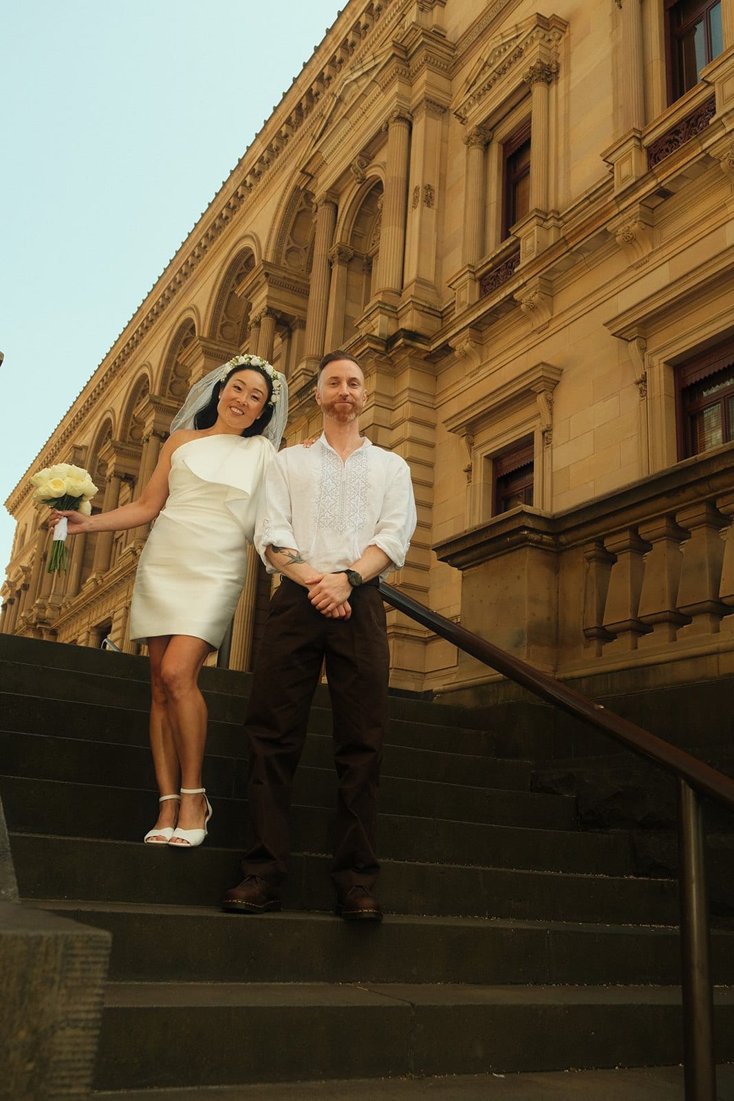 Cecile and Stefan on the sandstone steps beside the Old Treasury Building