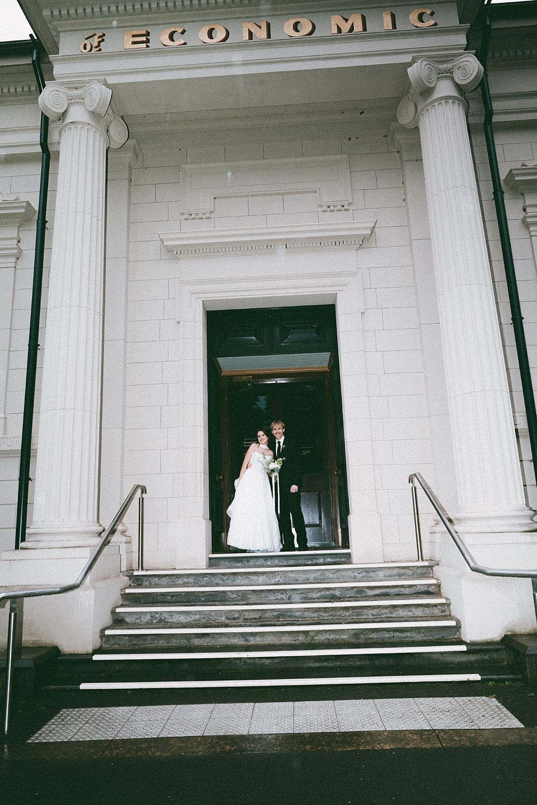 Eli and Charlotte in the columned doorway of the Museum of Economic Botany