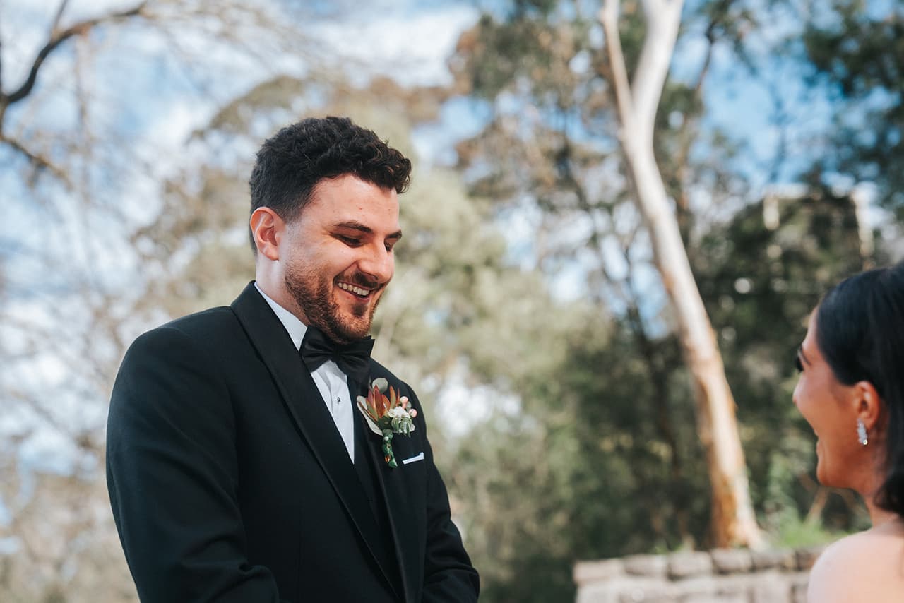 George grinning and looking down as he sees Tia for the first time, tall gums behind him
