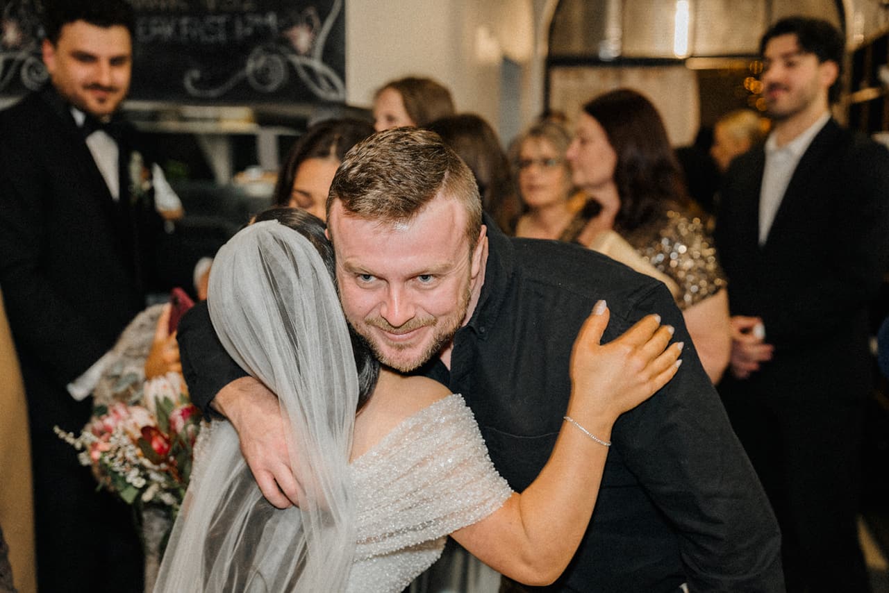 A guest hugging Tia after the ceremony