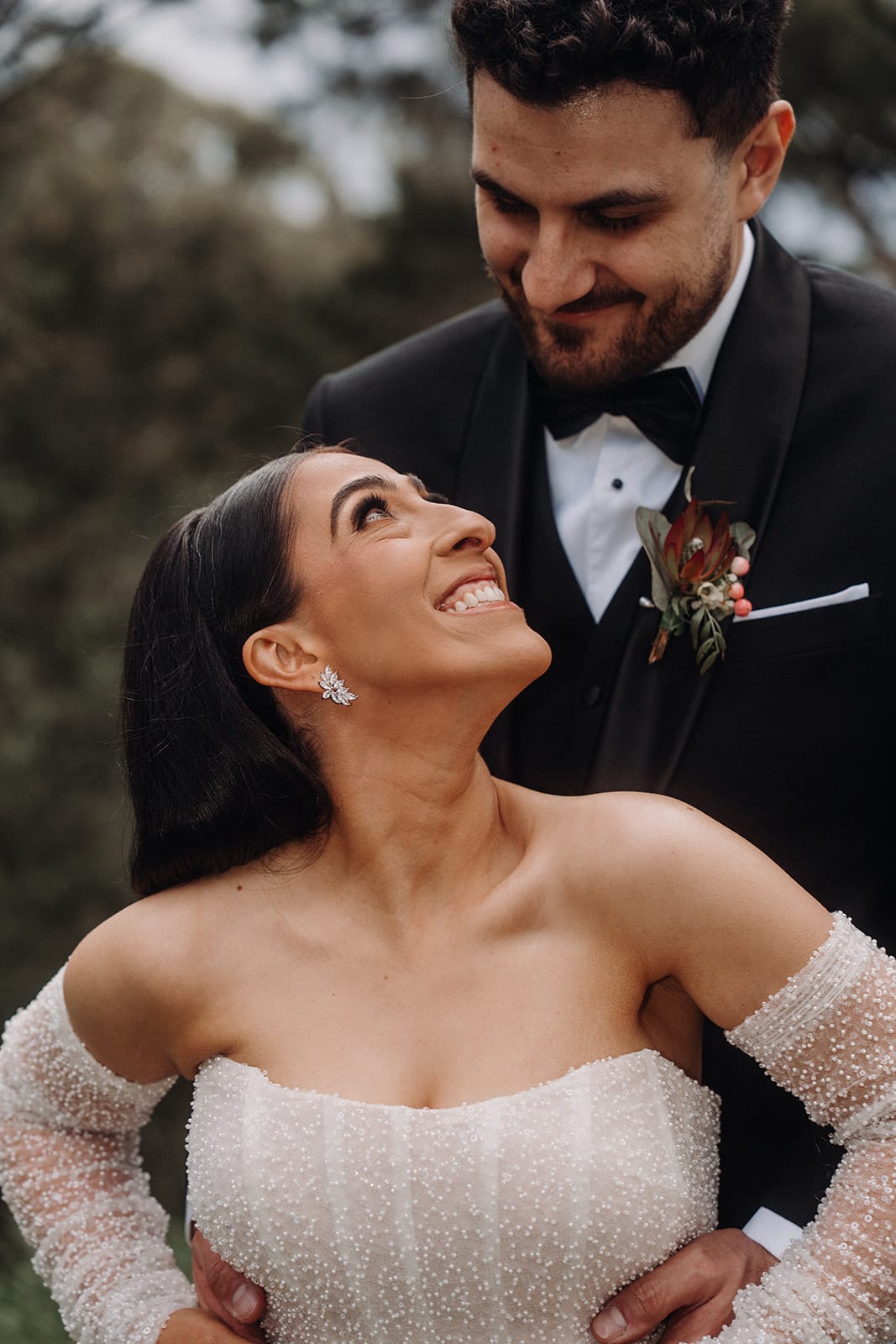 Tia looking up at George as he leans in close