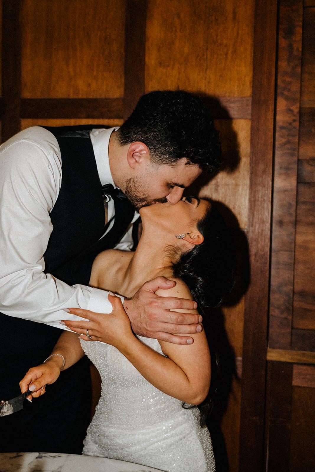 George and Tia kissing against the timber panelling late in the night