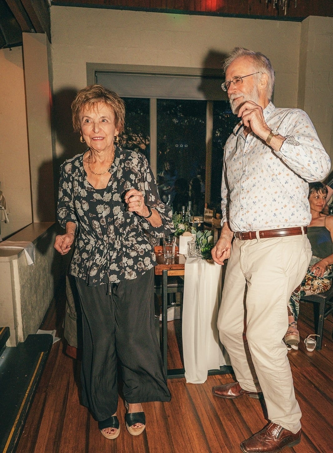 Two older guests dancing on the timber floor of the hall