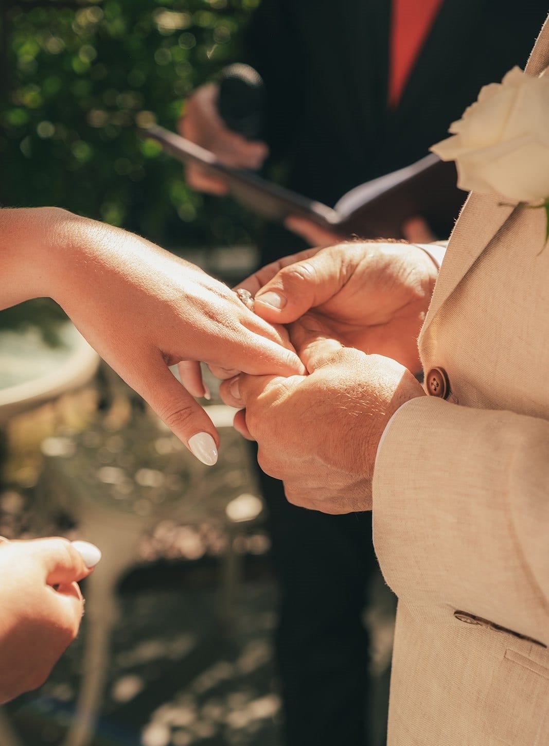 Close up of a ring going onto a finger during the ceremony