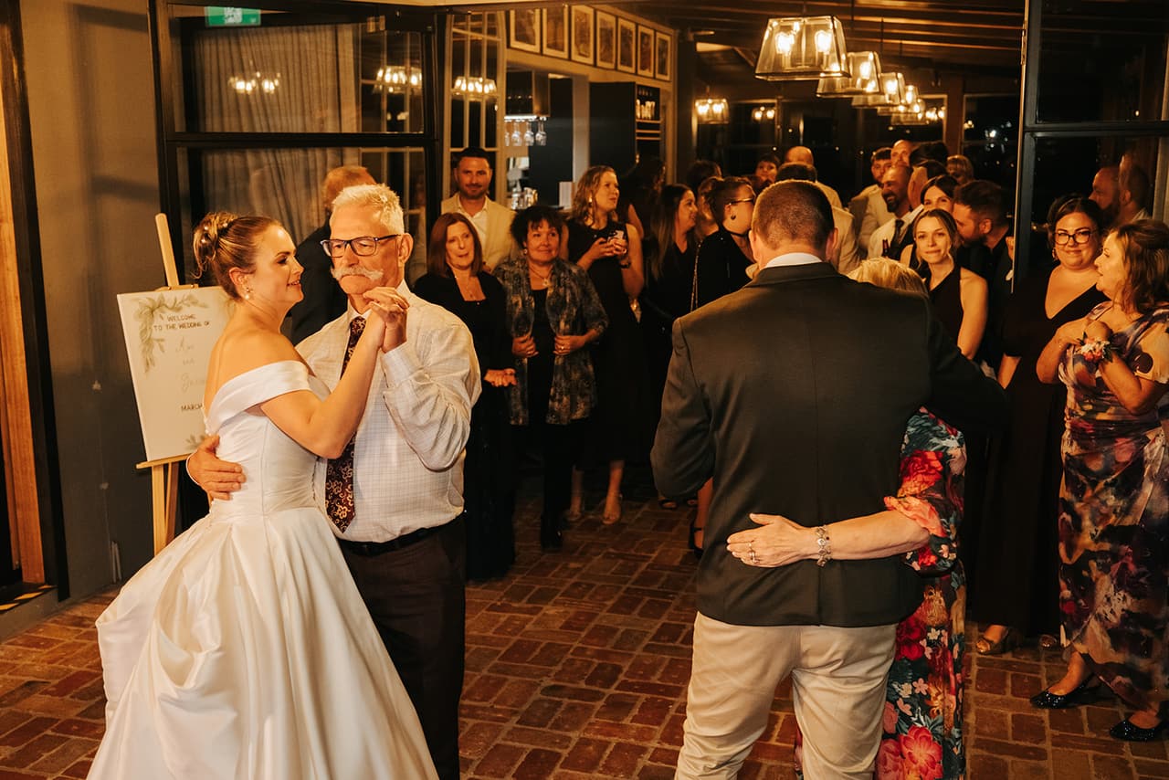 Jessica dancing with her dad as their guests gather round