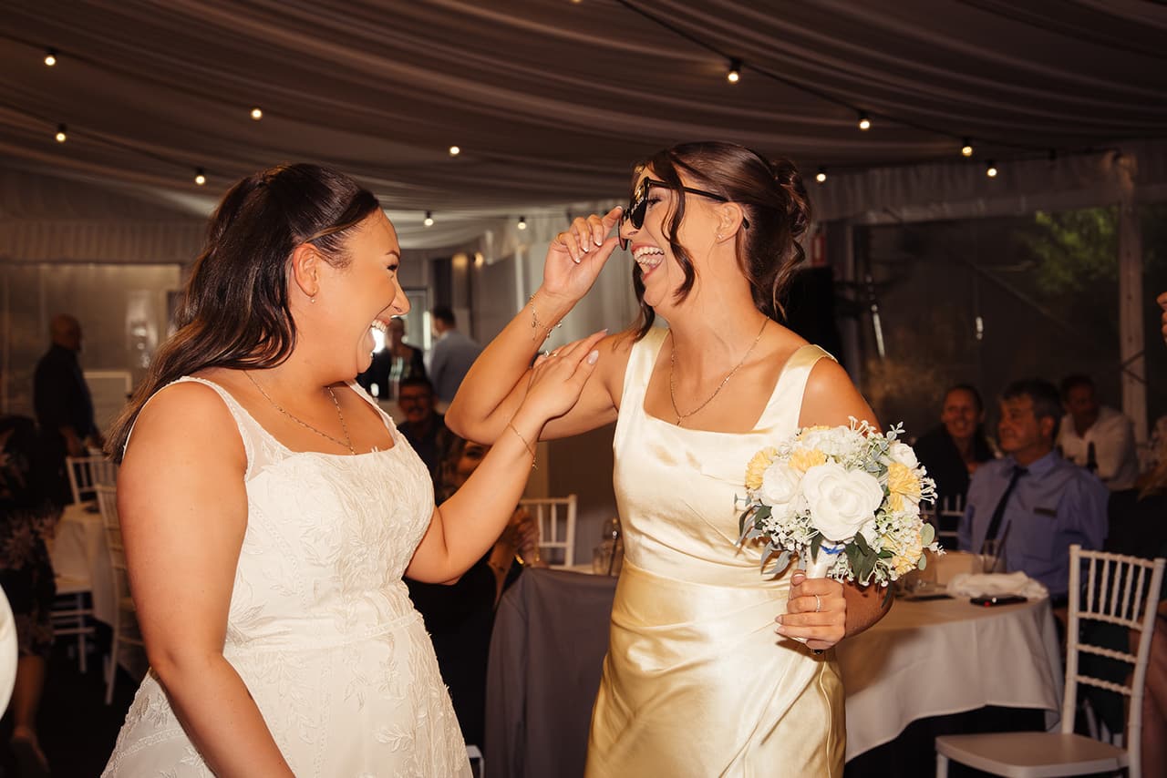 Karina laughing with a friend in the middle of the dance floor