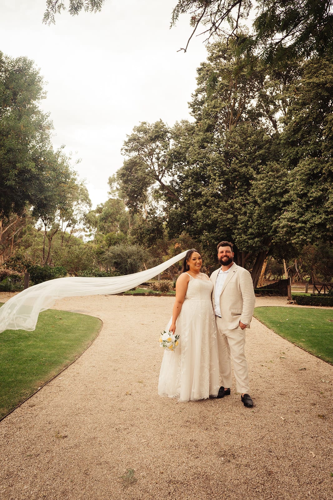 Karina and Bronson on the long driveway, her veil streaming out behind her