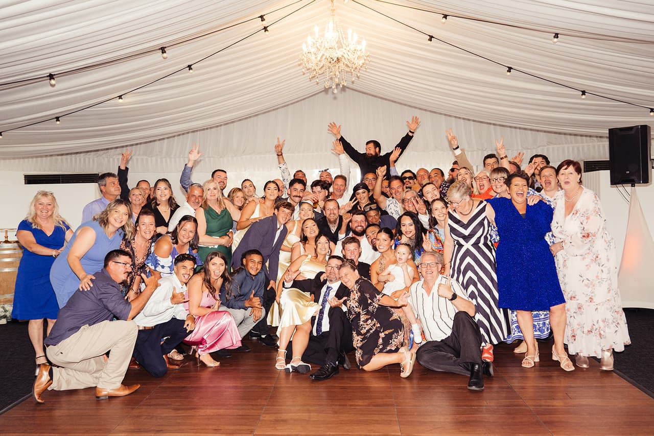 All the guests crowded onto the dance floor for one big photo, arms in the air