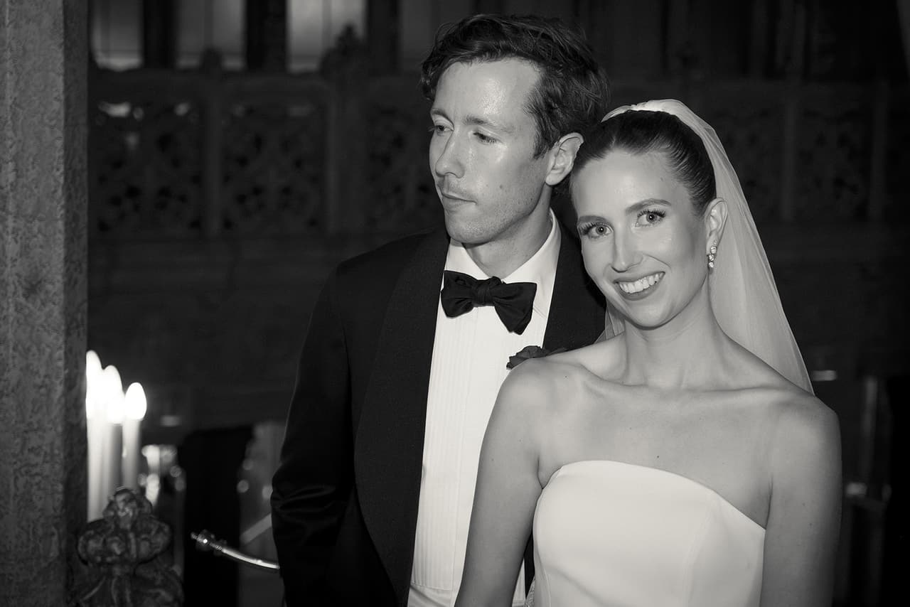 Black and white photo of Nick and Kira close together in the Regent Theatre, her veil over her shoulders