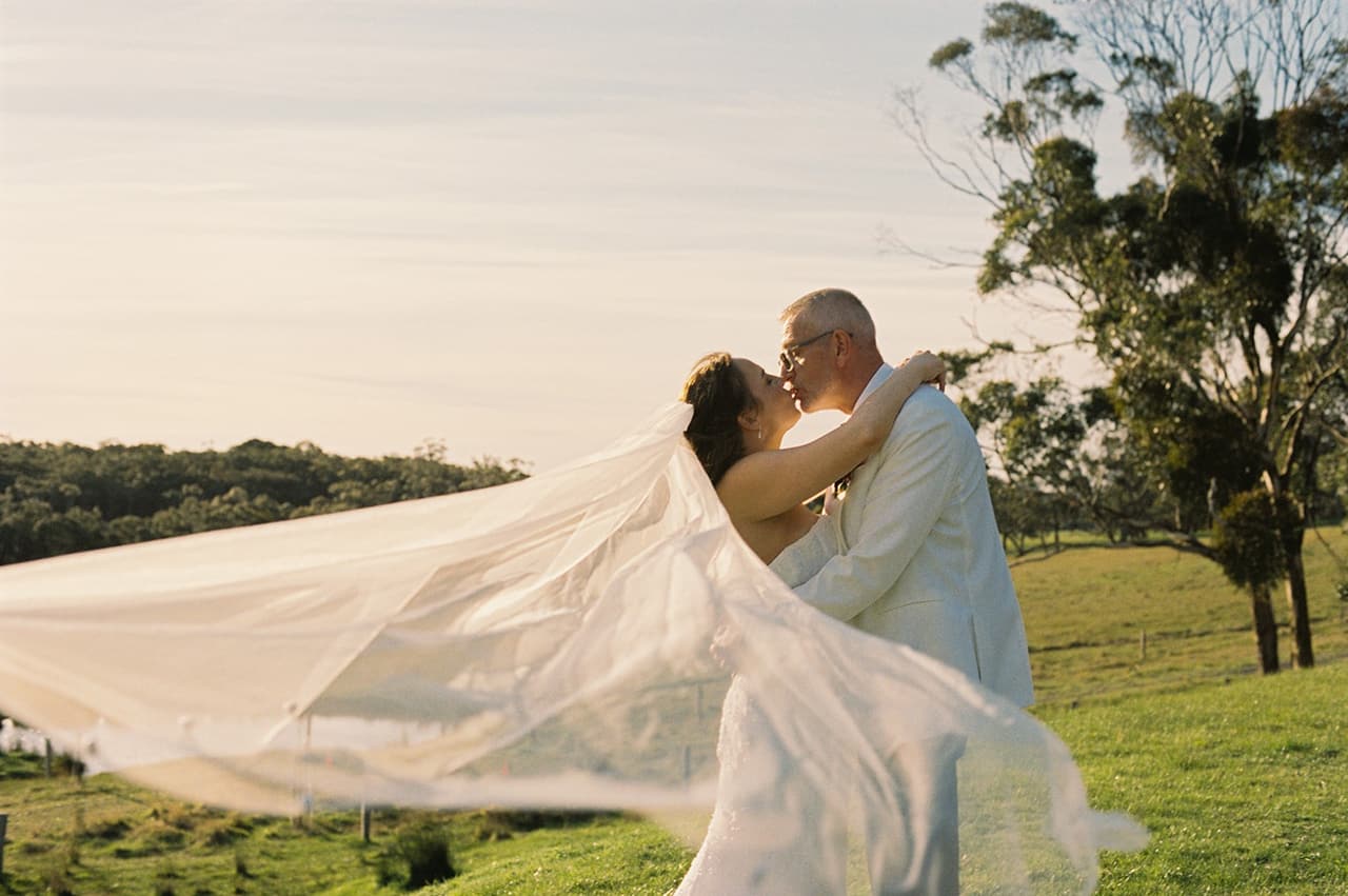 Kristie's veil lifting in the wind as she and Gareth kiss on the hillside, on 35mm film