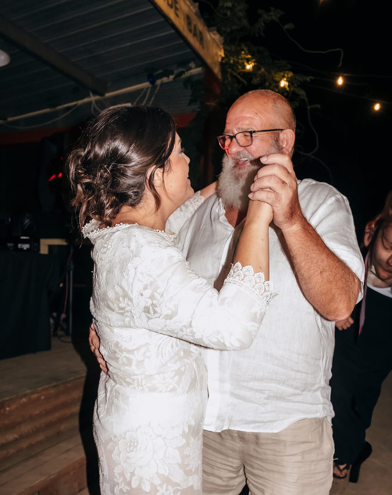 Lana dancing with her dad under the festoon lights