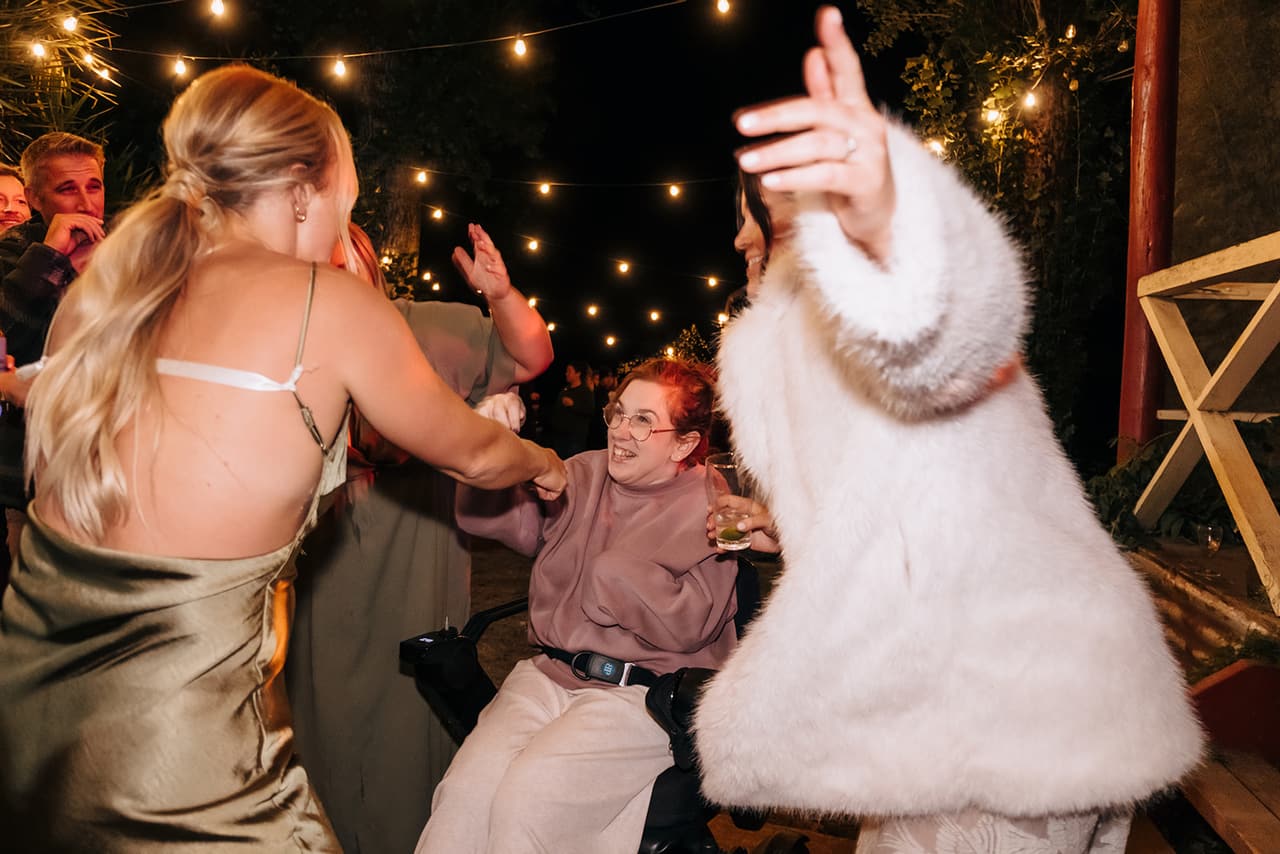Lana in her faux fur coat dancing wildly with friends late in the night