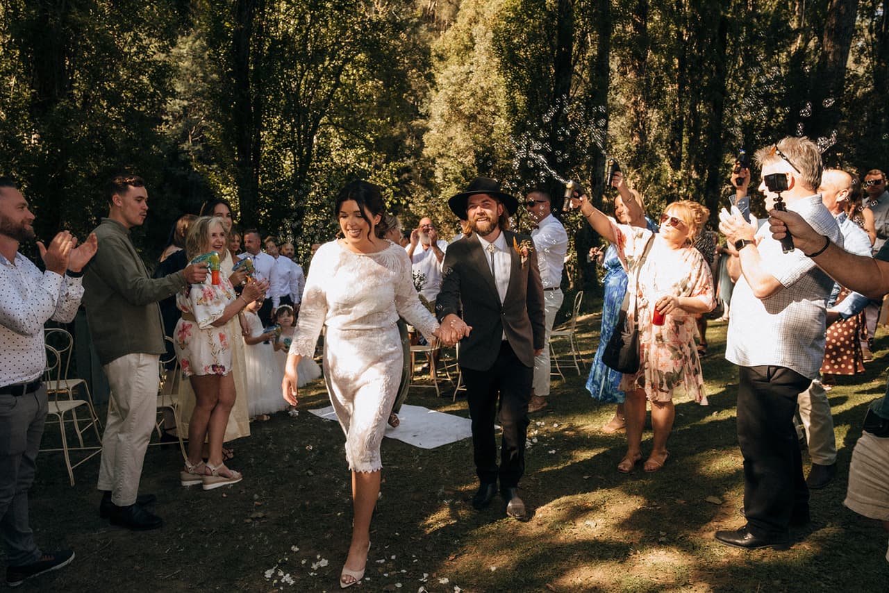 Lana and Todd walking back through their guests in a shower of confetti