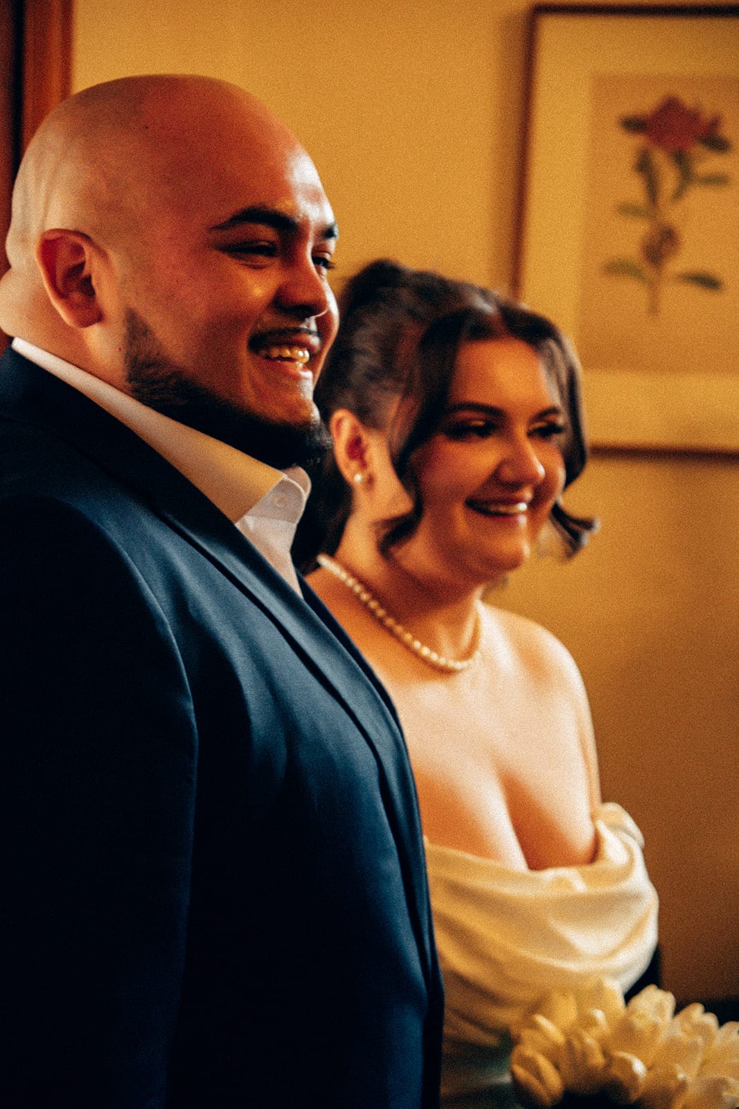 Diego laughing beside Martina in the warm light of the ceremony room