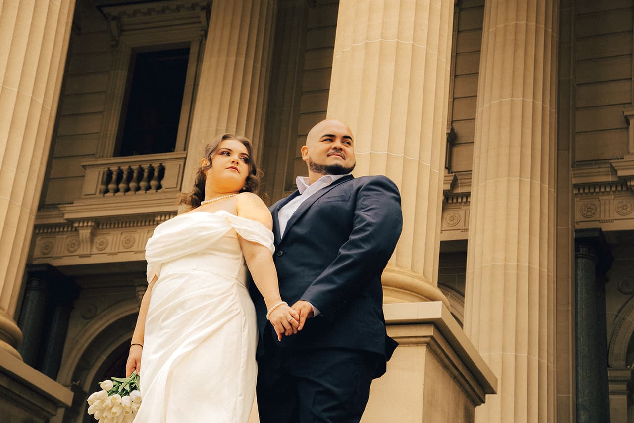 Martina and Diego on the steps of Parliament House beneath its columns