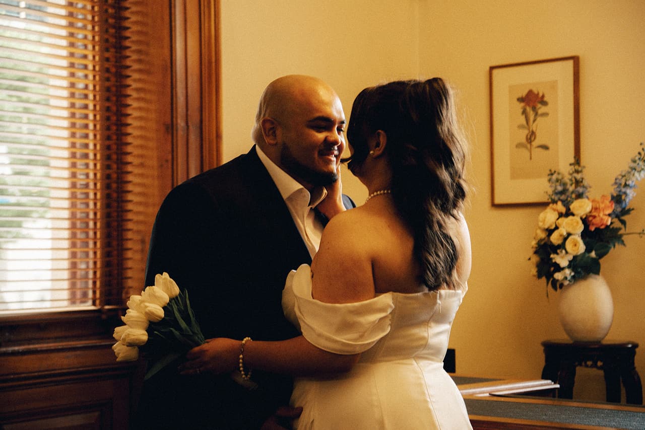 Martina and Diego holding each other in the warm timber room of the marriage registry