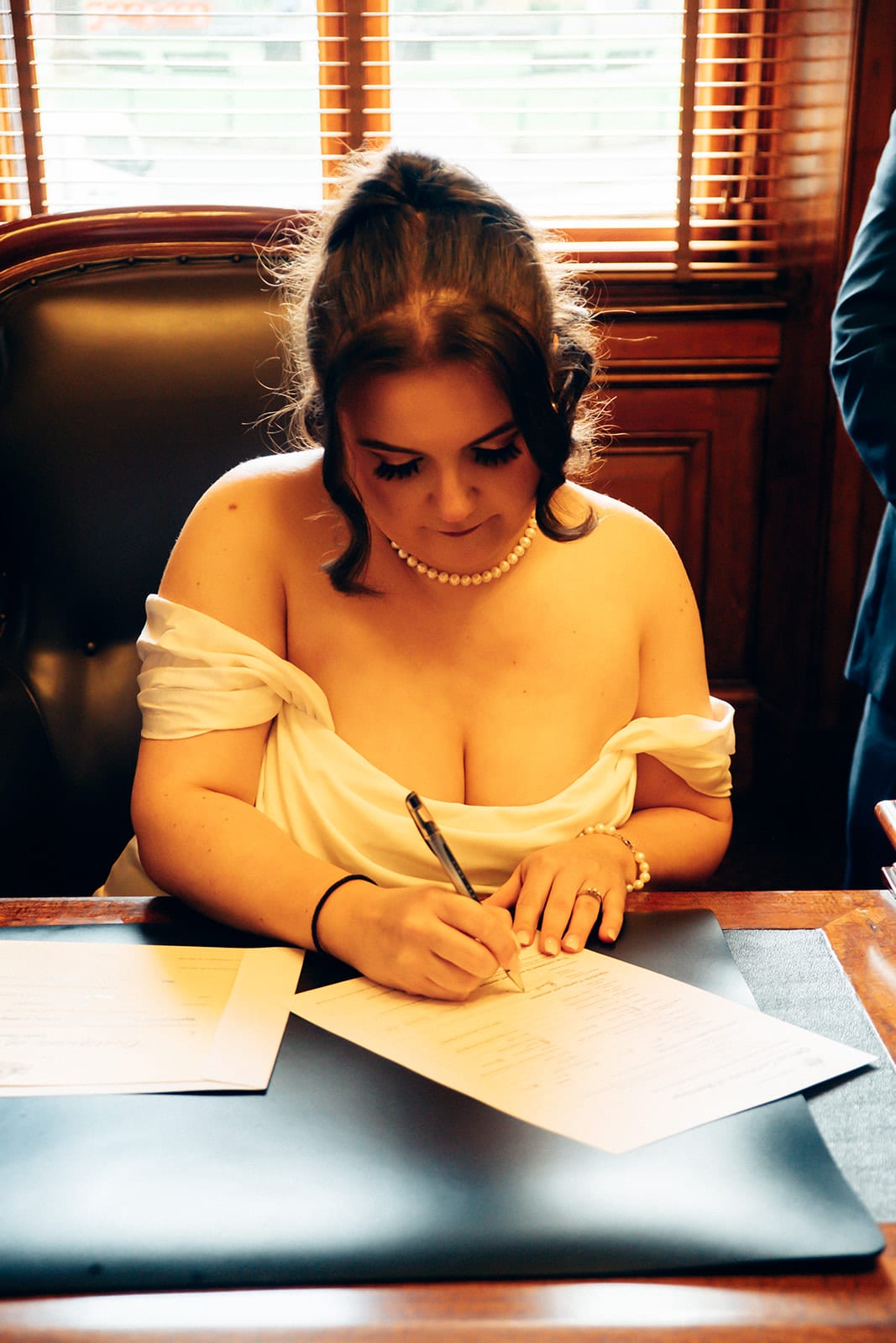Martina signing the register at the desk