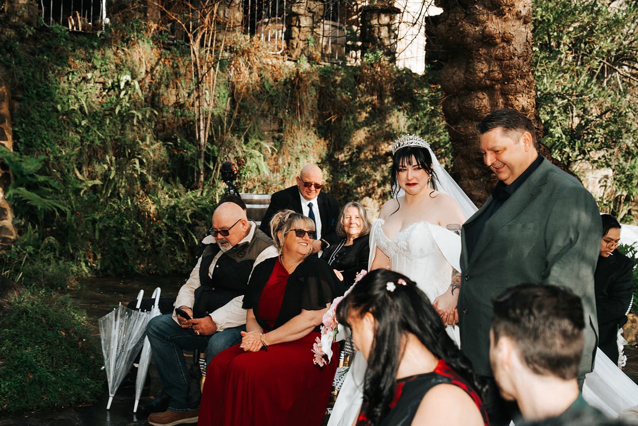 Porscha passing her guests on the way down the aisle with her dad