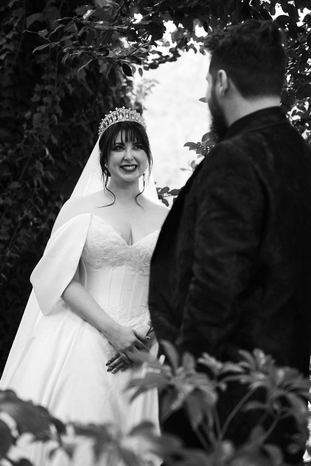 Black and white photo of Porscha smiling beside Jordan in the garden