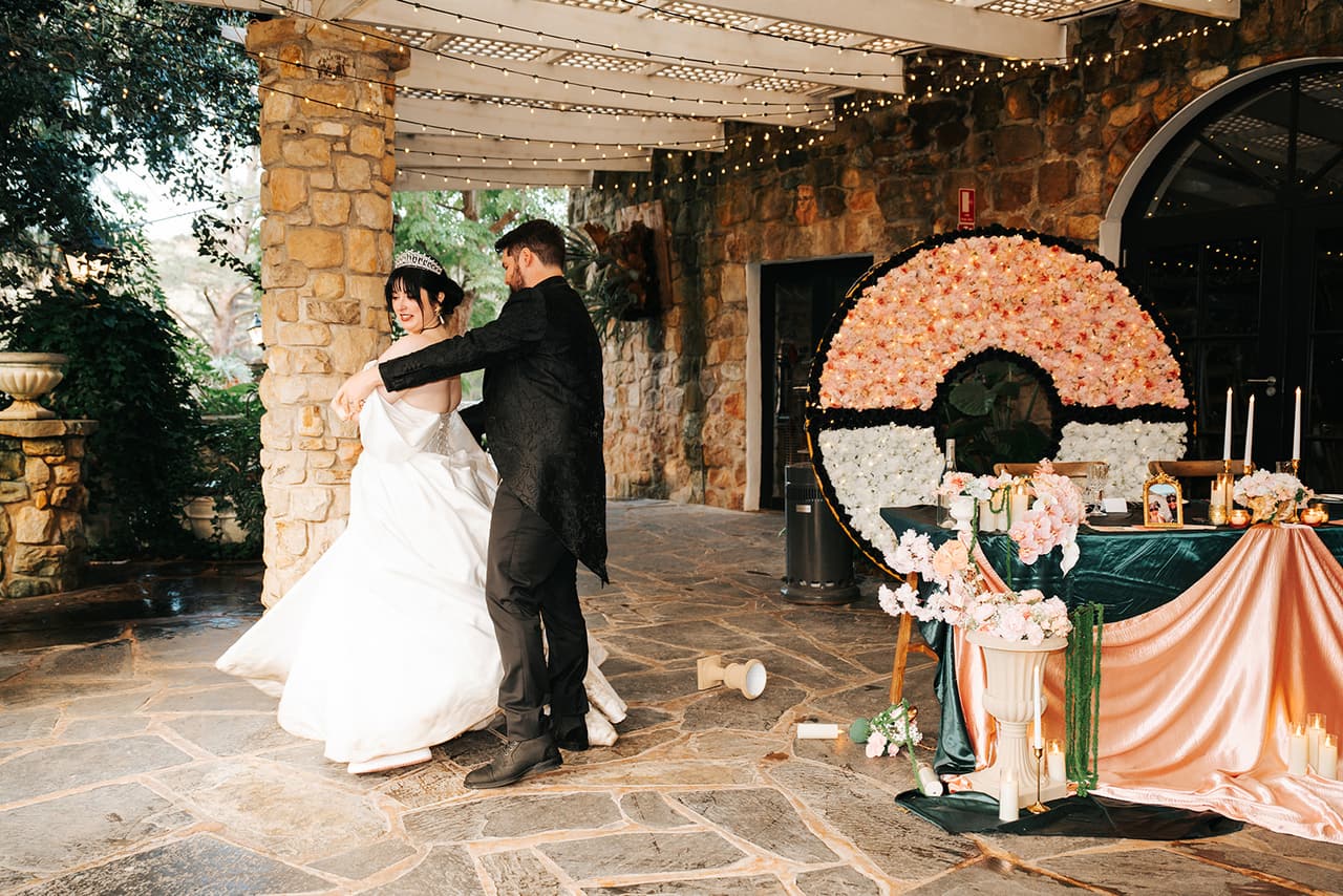Porscha and Jordan's first dance on the stone floor in front of the flower wall