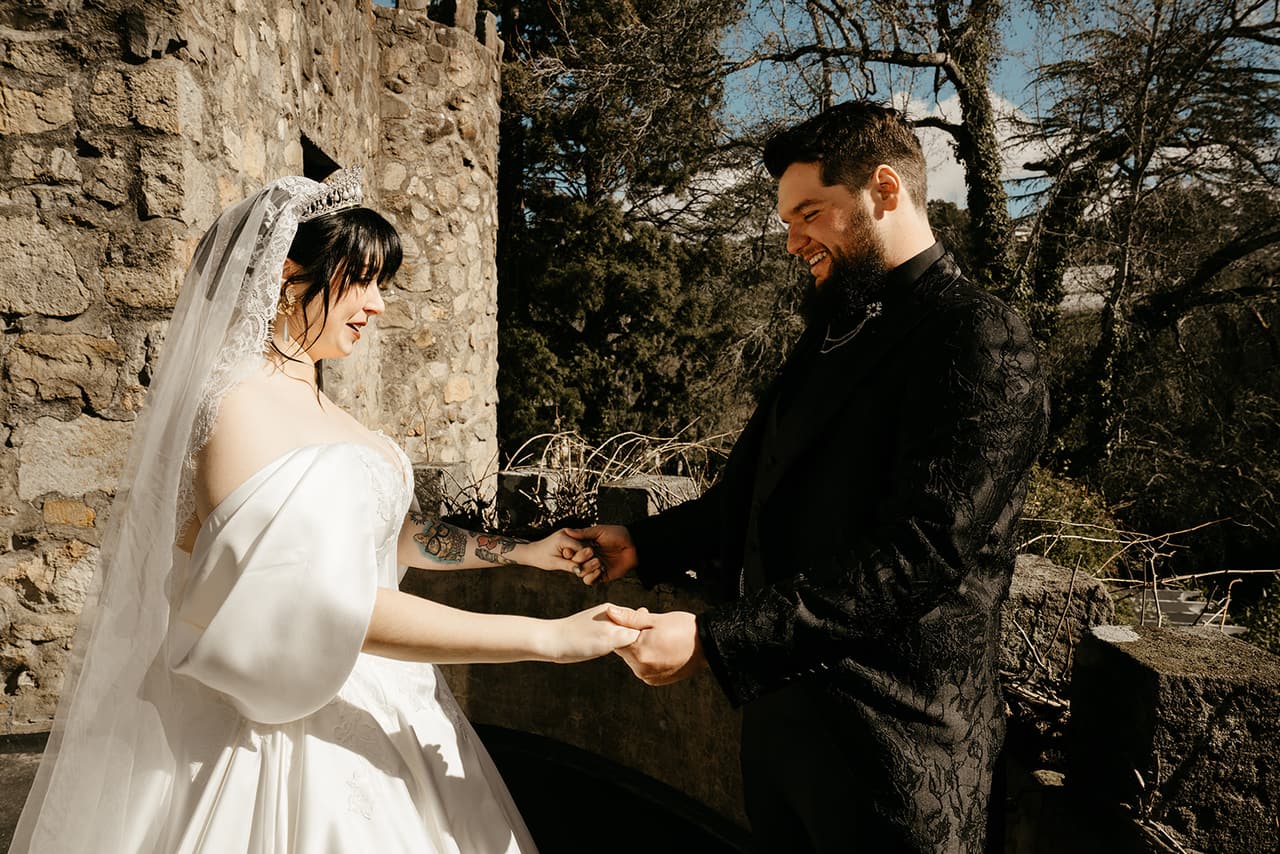 Porscha and Jordan holding hands at their first look beside the castle wall