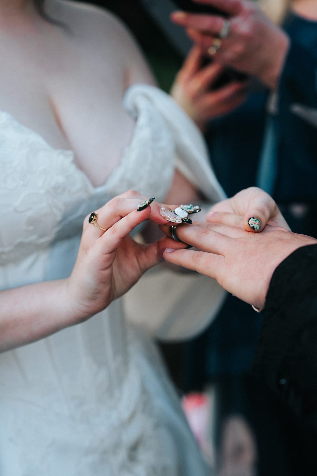 Close up of Porscha sliding the ring onto Jordan’s finger