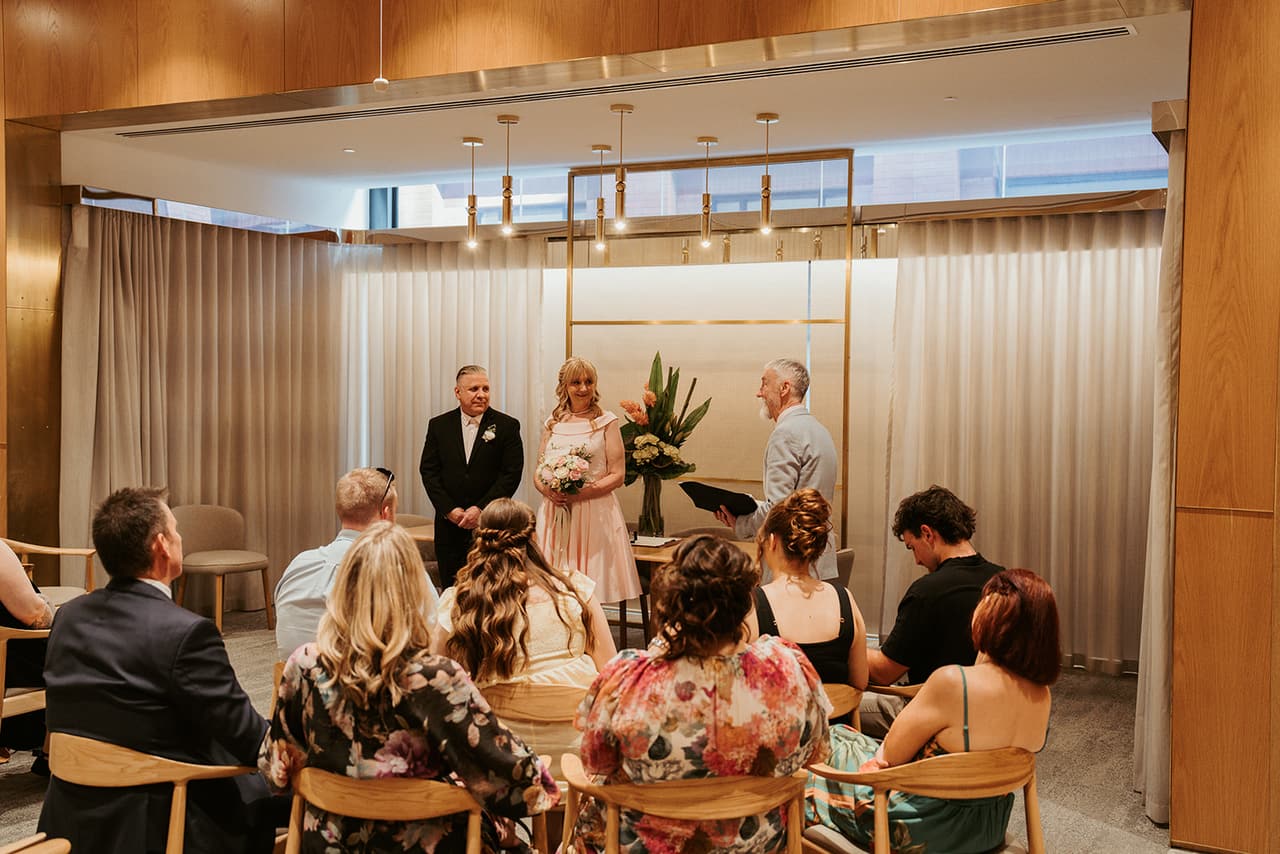 The ceremony room at the registry office, family and friends watching as Terrie and Jon stand at the front
